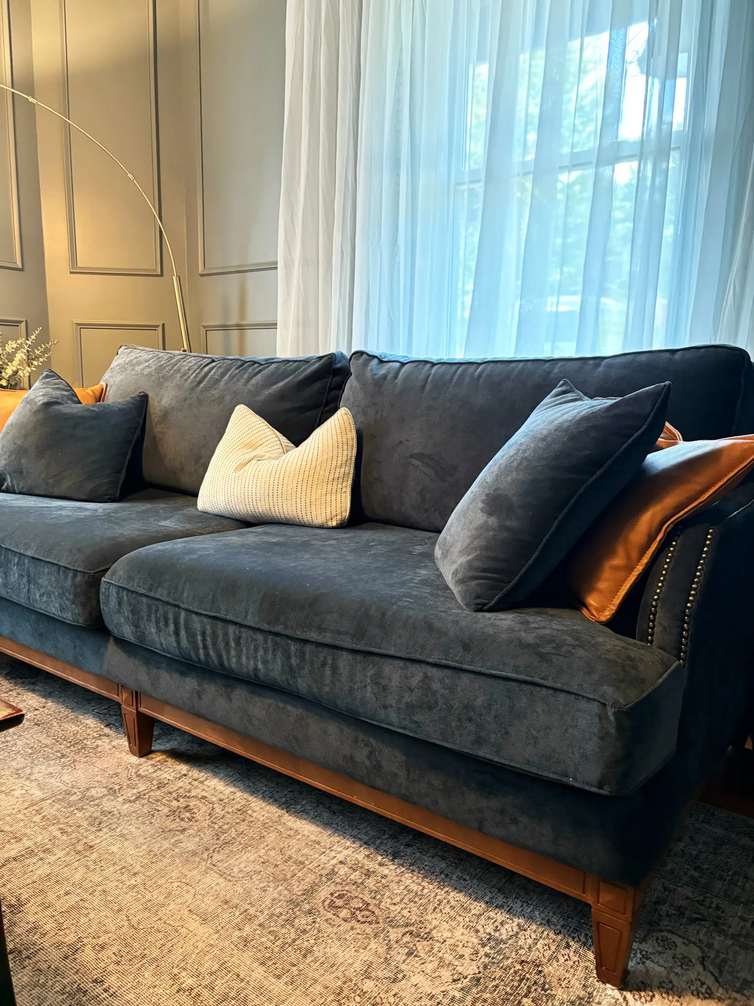Blue sofa with layered pillows in the living room