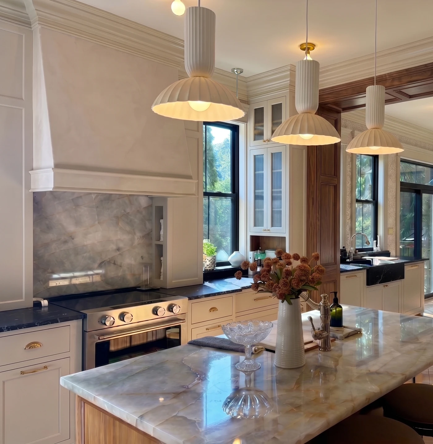 Kitchen view through a doorway beside a layered historic room with fireplace detail